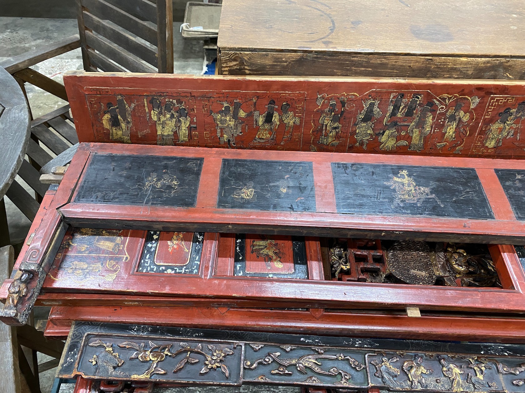 Nine sections of a Chinese red lacquered cabinet, with gilt figural decoration